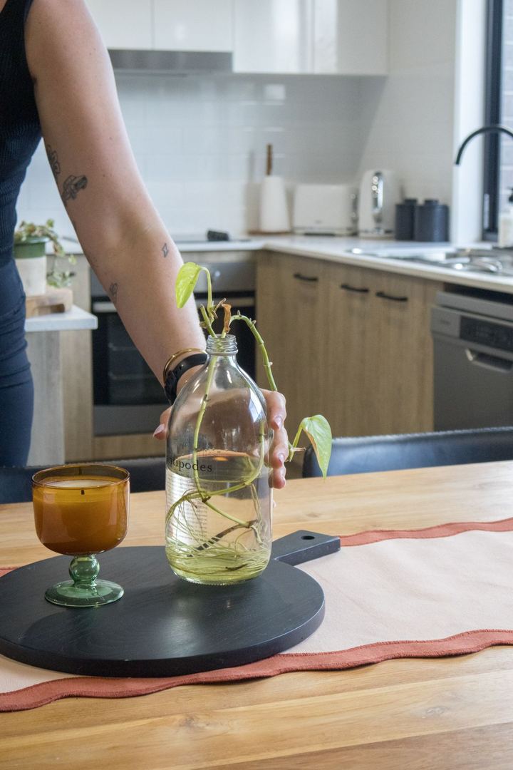 Aleka placing a vase on a freshly cleaned kitchen table after a Spring Clean