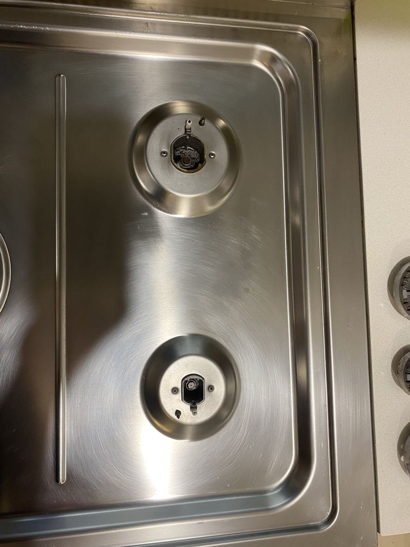 Stainless steel gas hob gleaming after cleaning